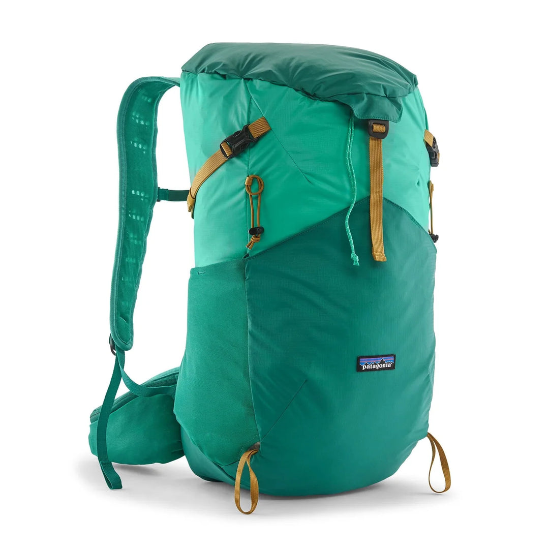 Patagonia Terravia Pack 28L Aqua Stone — front view with top-loading roll closure and orange accents