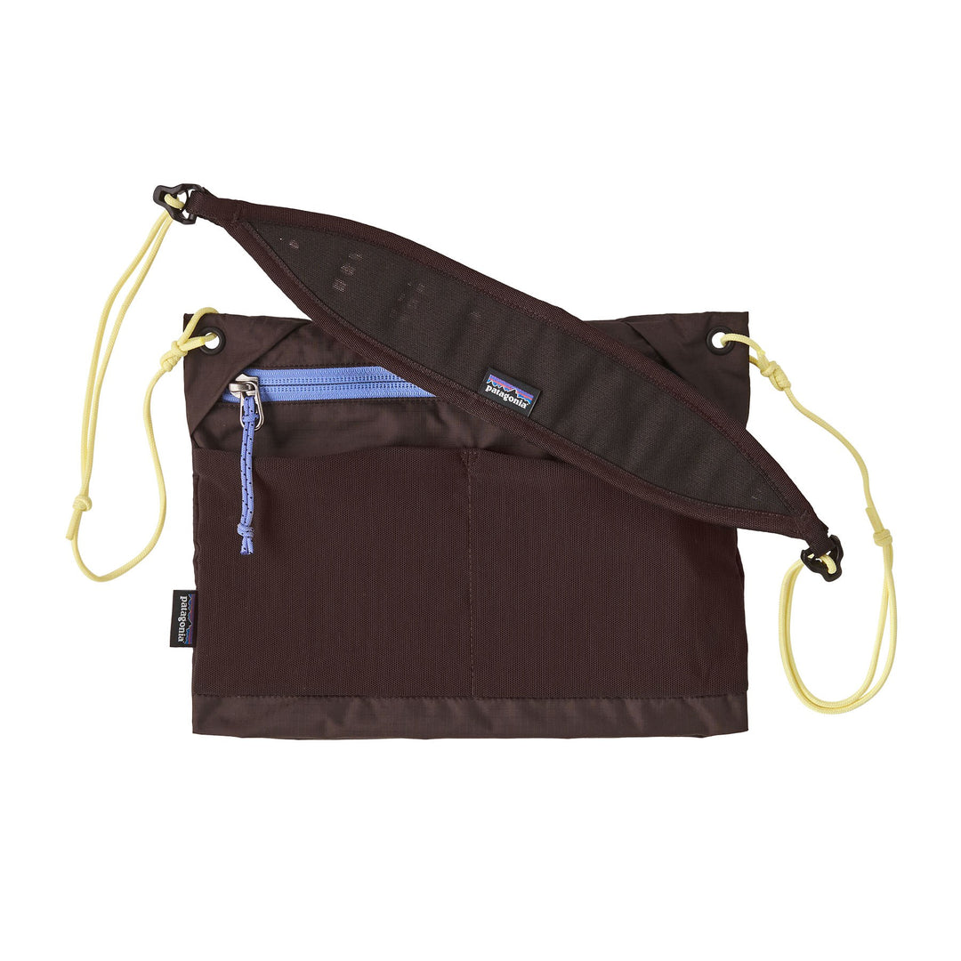 Patagonia Terravia Sacoche 3L in Den Brown — front view with yellow cord strap and blue zip