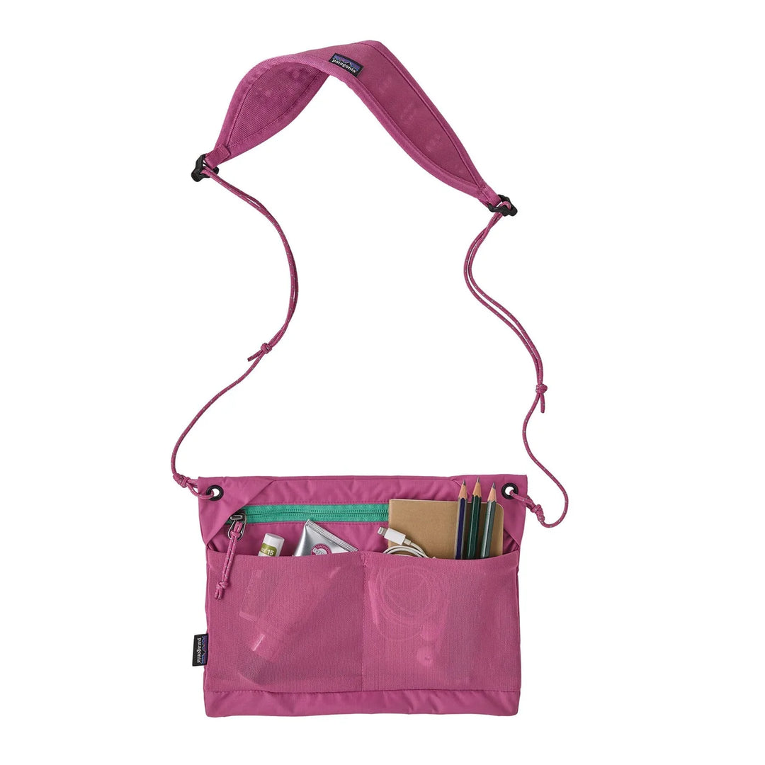 Sacoche Bag 3L Flame Dark Magenta open with pencils, notebook, charger, and everyday carry items