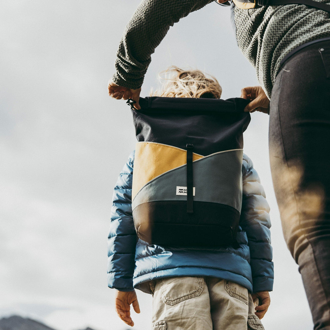 Popoyo kids backpack with rolltop open in lifestyle setting