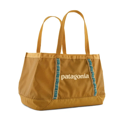 Front view of the mustard tote bag with contrast straps and logo detail