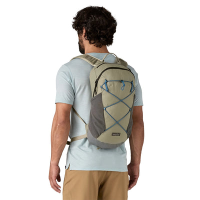 Front view of man wearing a technical daypack in River Rock Green for day hikes and short outings