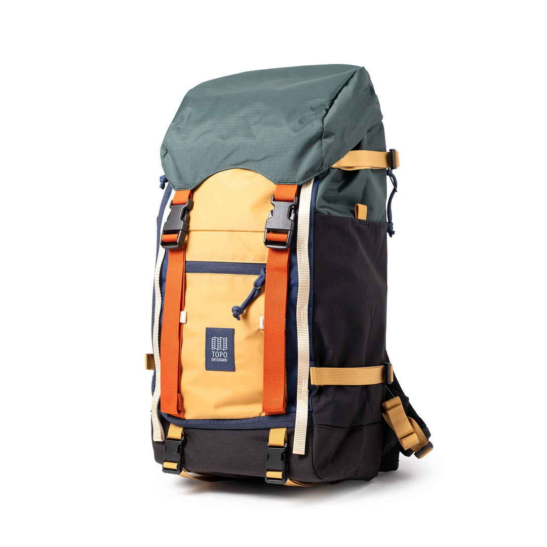 Rover Trail Pack 24L in Forest and Goldenrod — three-quarter view showing the side compression straps