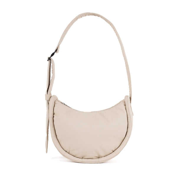 Sandqvist Curve Half Moon Bag Mini in beige — front view of the 3L compact crossbody bag
