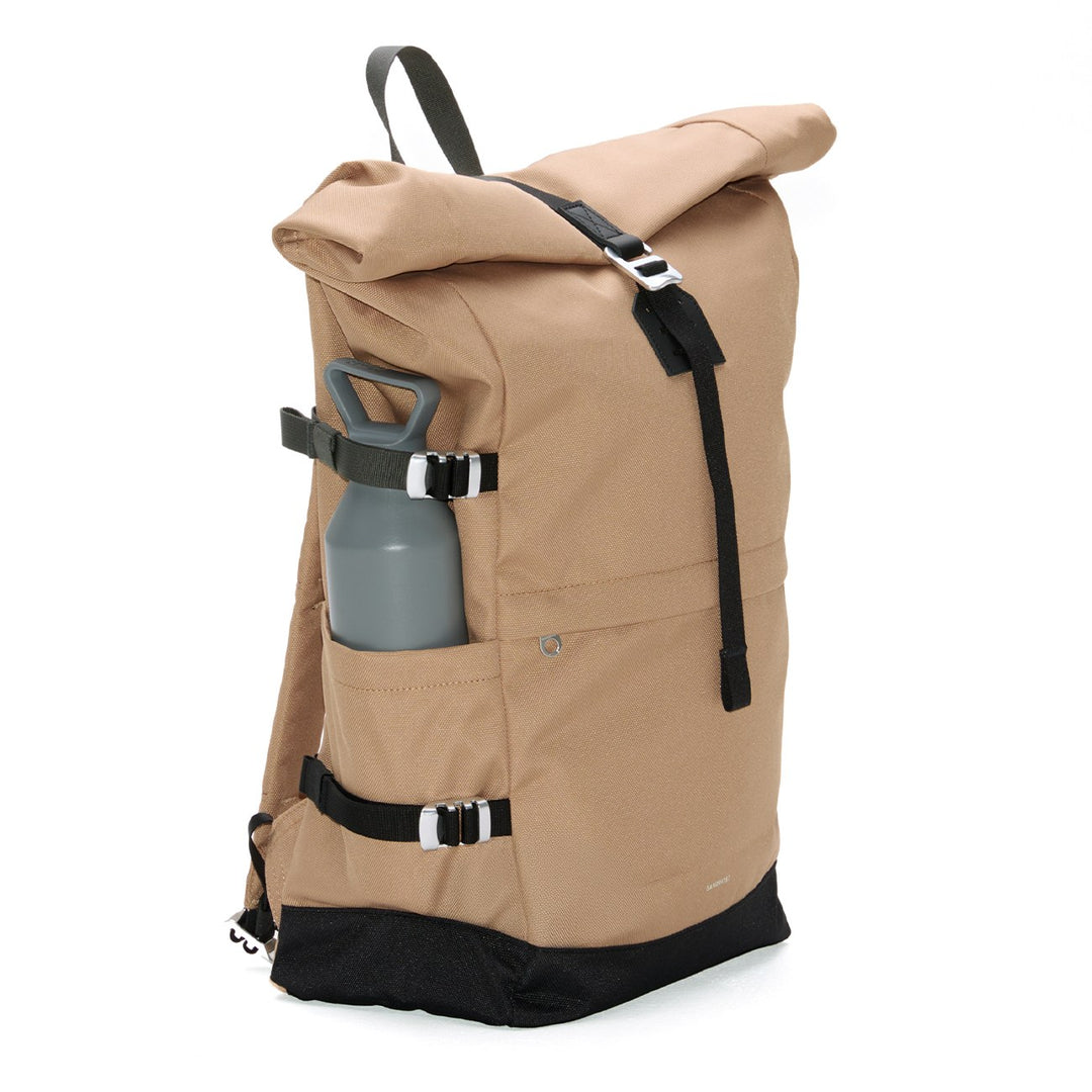 Three-quarter view of the Sandqvist Icon Rolltop Backpack L in beige with side bottle pocket