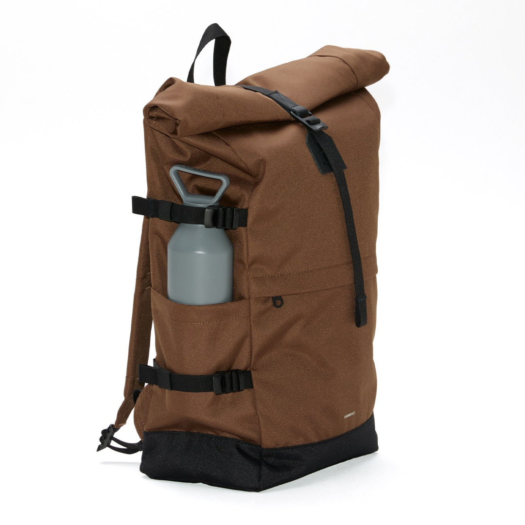 Three-quarter view of the Sandqvist Icon Rolltop Backpack L in brown with side bottle pocket