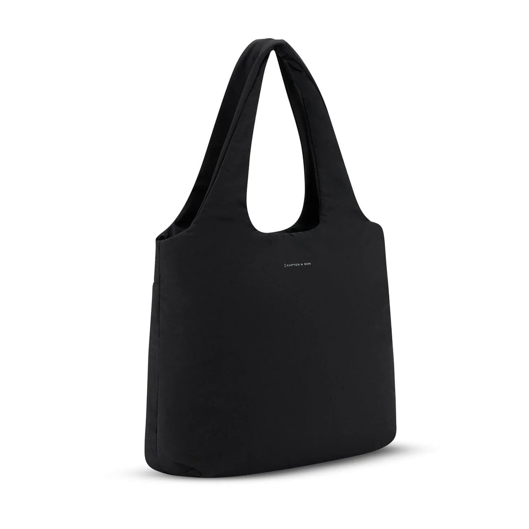 Side angle showing the soft padded volume and minimalist logo