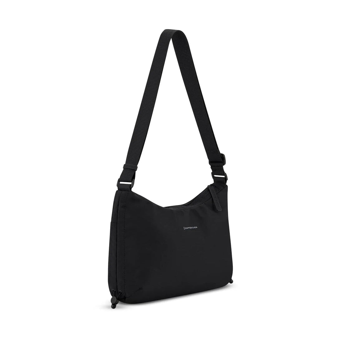 Three-quarter angle showing the crescent silhouette and adjustable strap