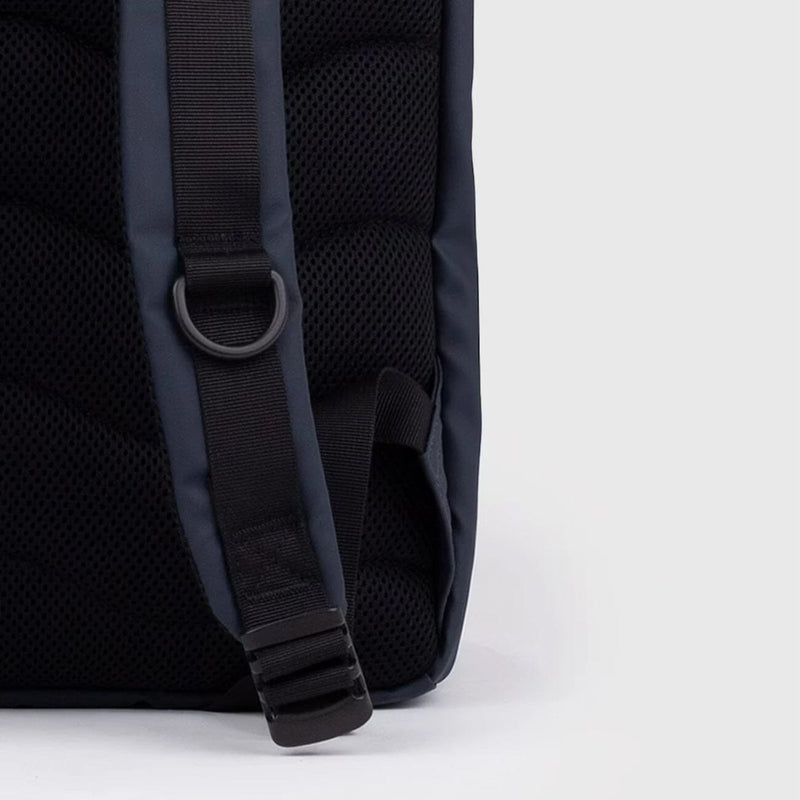 Close-up of the padded back panel and adjustable shoulder strap of the navy waterproof rolltop backpack, designed for comfort and everyday carry