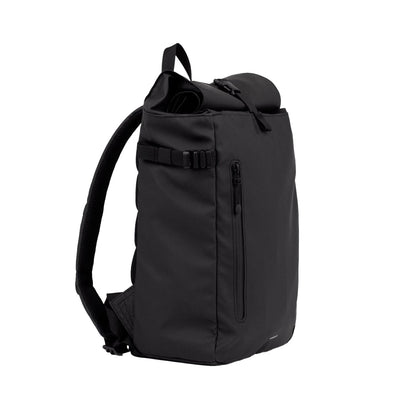 Side angled view of the slim black rolltop backpack, showing adjustable straps, waterproof zippers, and rolltop closure flexibility