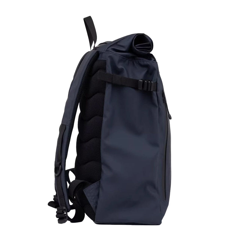 Streamlined side profile of the slim navy rolltop backpack with adjustable straps and padded back support