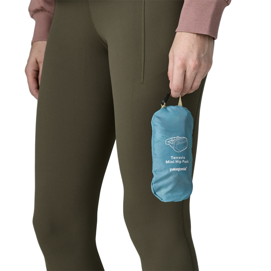 Terravia Mini Hip Pack packed into its own zippered pouch, held in hand