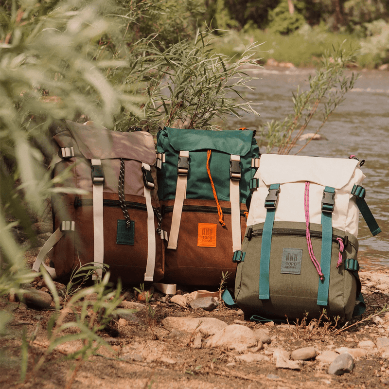 three rover pack classic bags laying forest ground