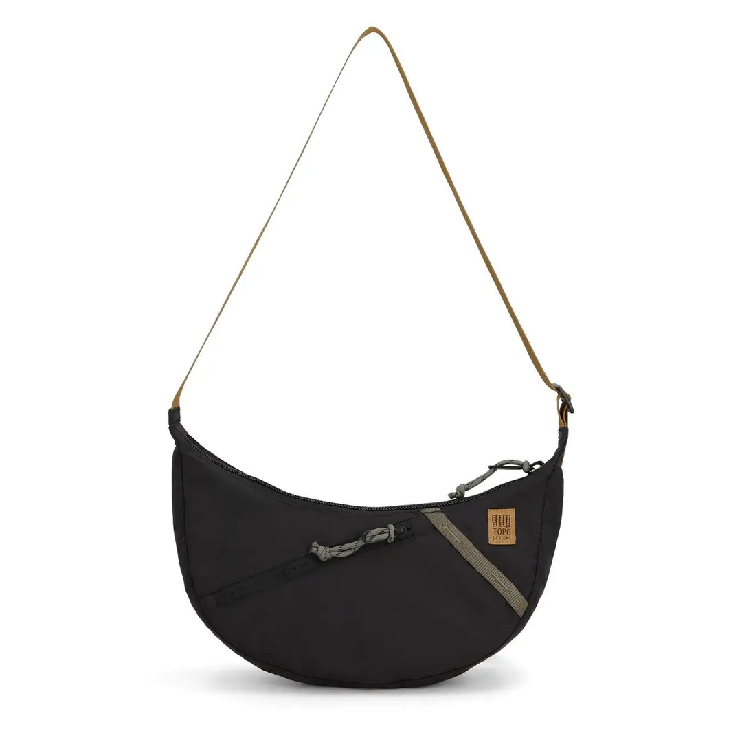 Front view of Topo Designs Moonlight crossbody bag in black with camel strap and contrast zipper