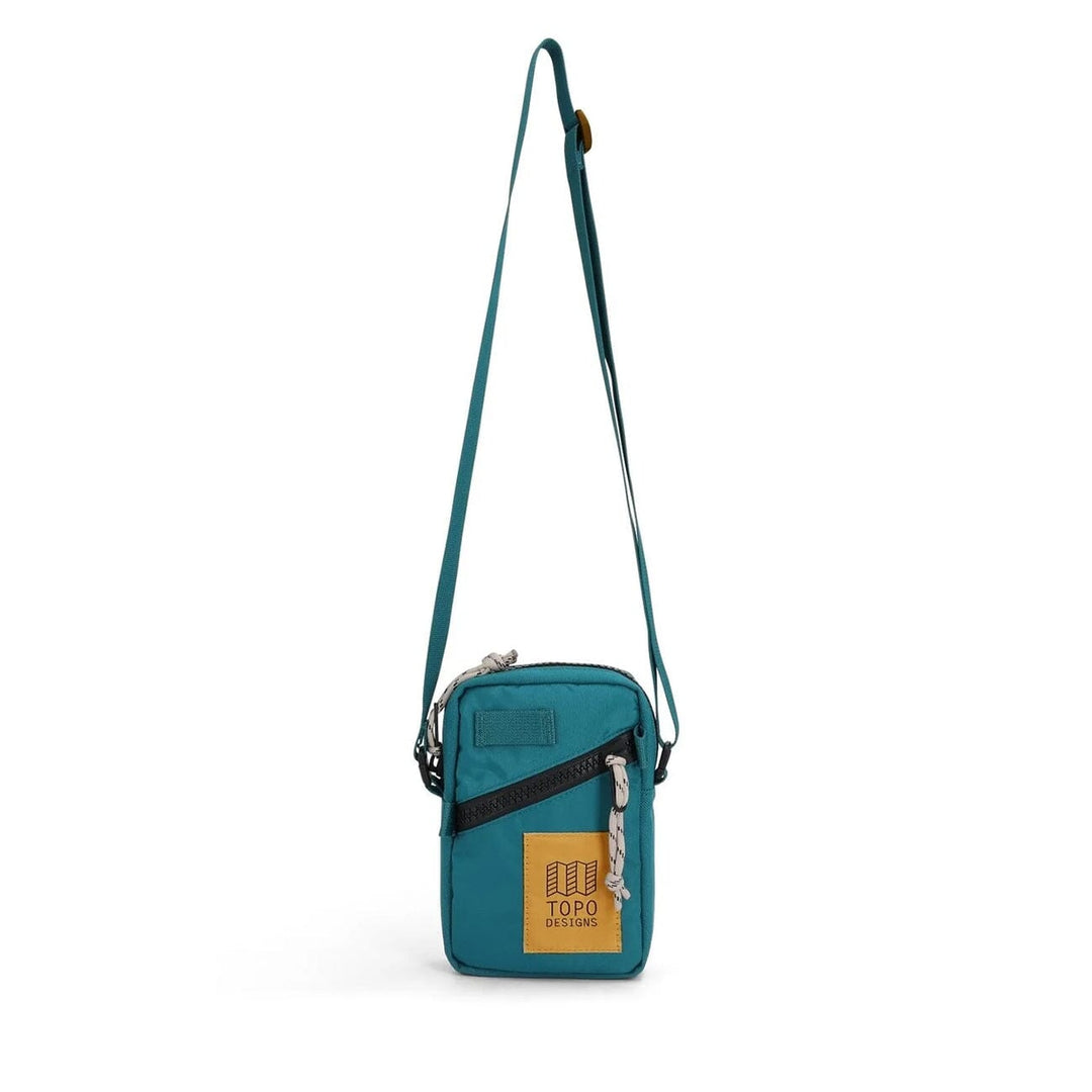 Topo Designs Mini Shoulder Bag in spruce — front view with deep teal body and pattern strap