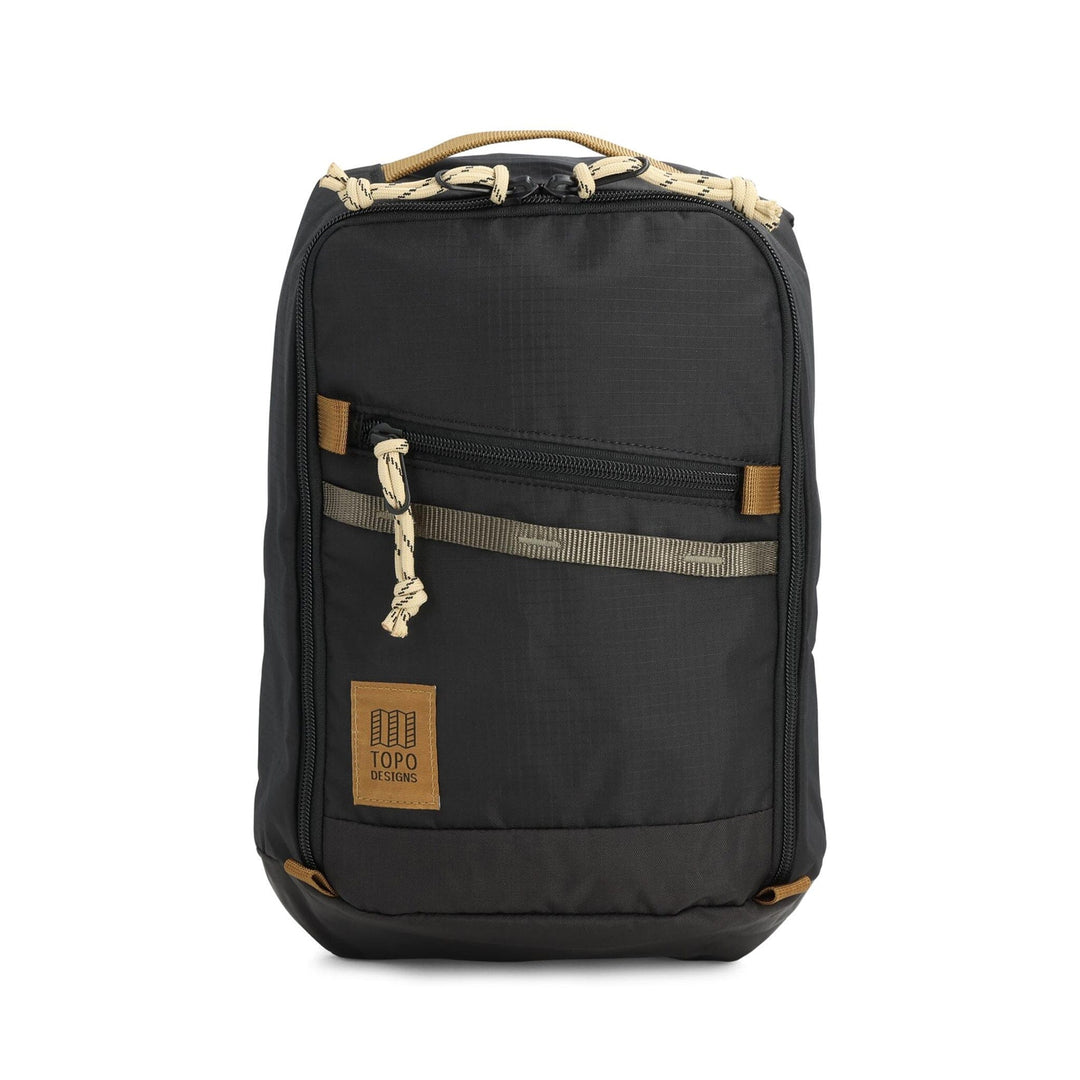 Topo Designs Mountain Sling Bag in black and neutral — front view with all-black body and tan webbing