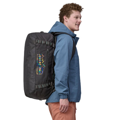 Traveler carrying the Patagonia 55L duffel as a backpack during urban commute