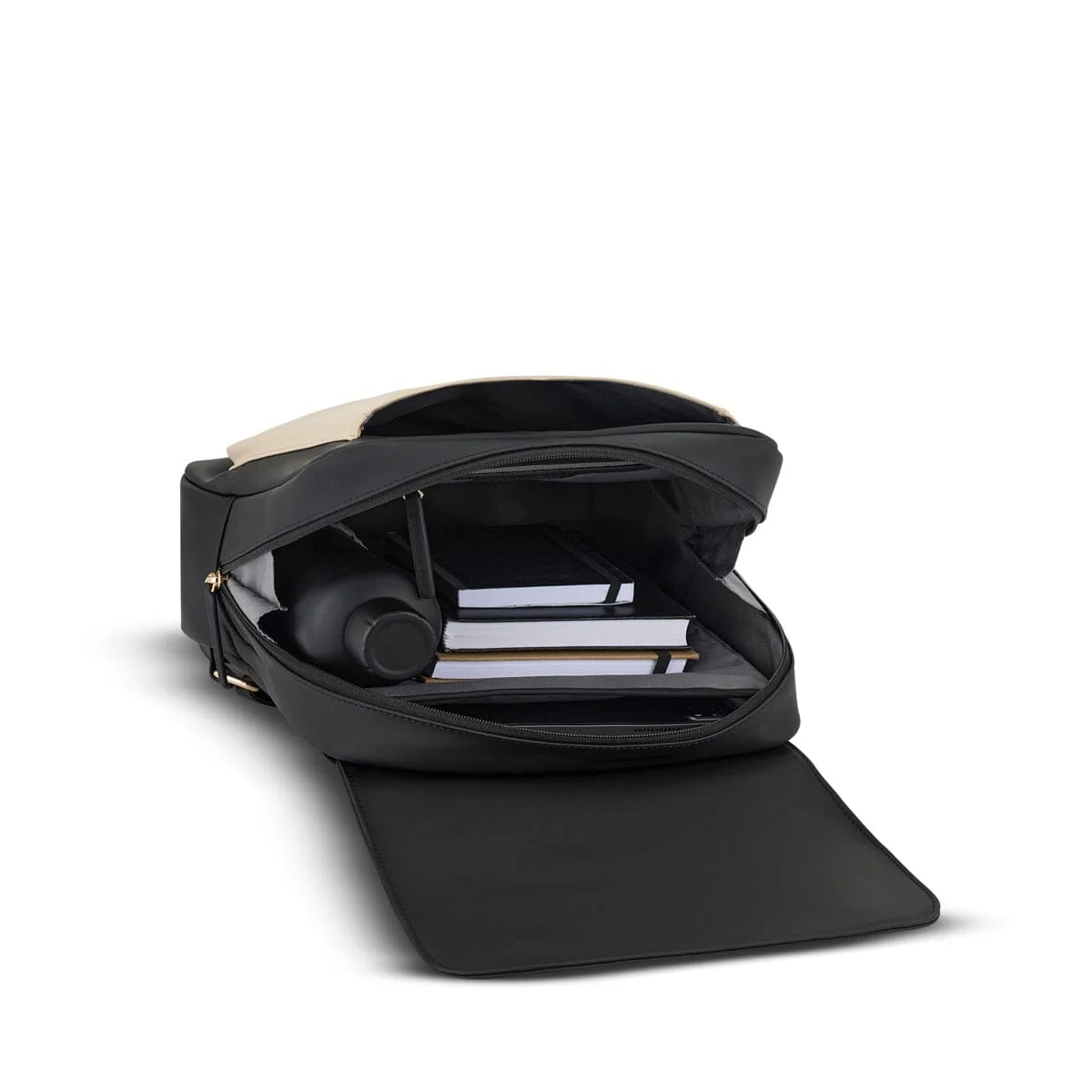 Interior of the cream black Tromso packed with a water bottle and notebooks