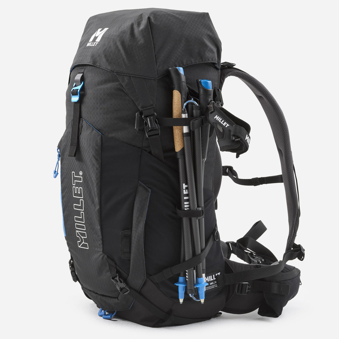 Millet UBIC 30L black — trekking poles in side carry, three-quarter view