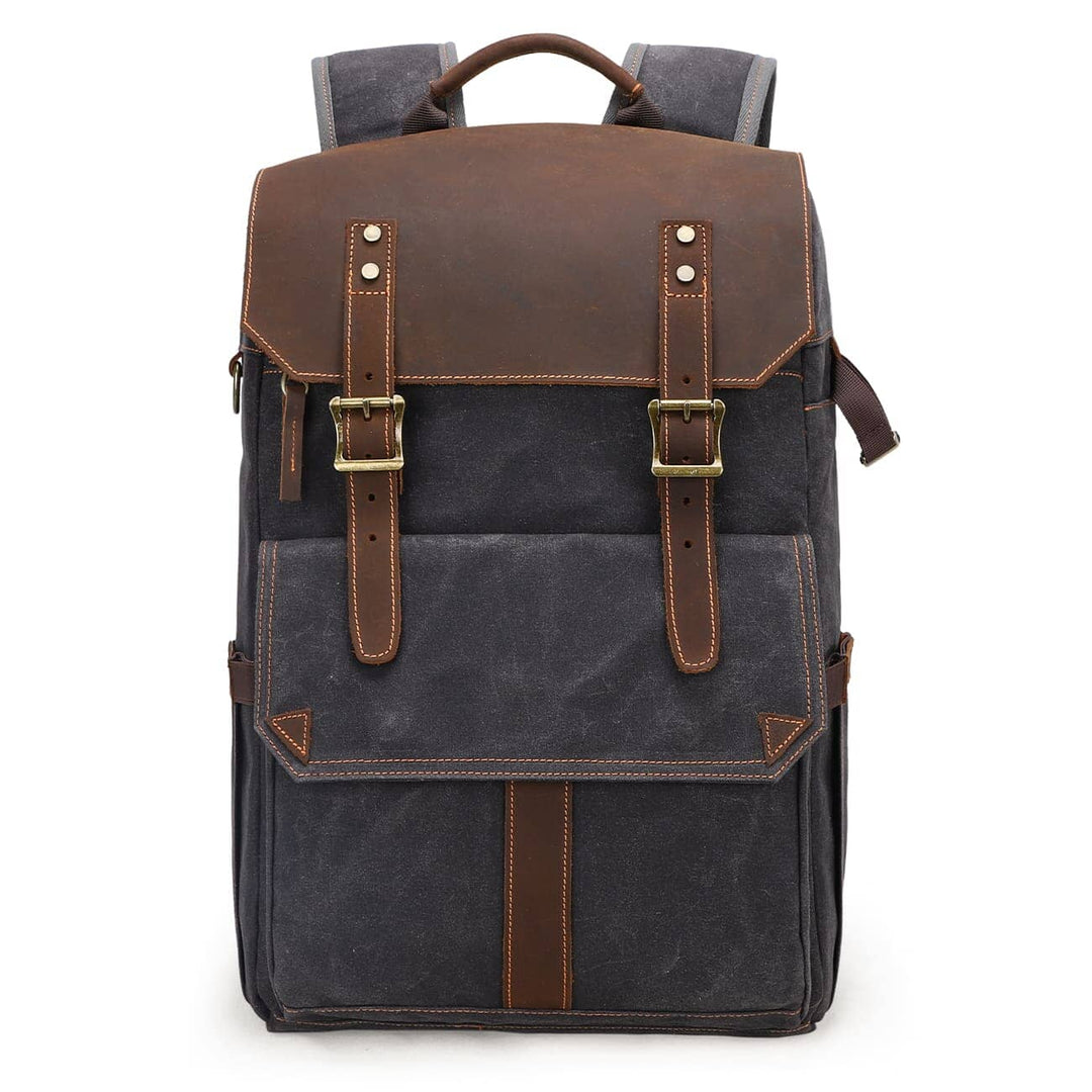 Waxed canvas camera backpack in dark grey with full-grain leather top flap, brass square buckles and front utility pocket — Algonquin