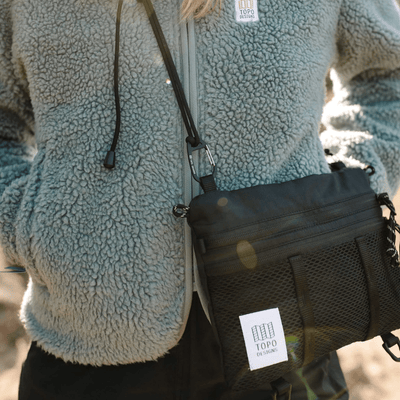 woman hiking wearing topo designs mountain accessory shoulder bag