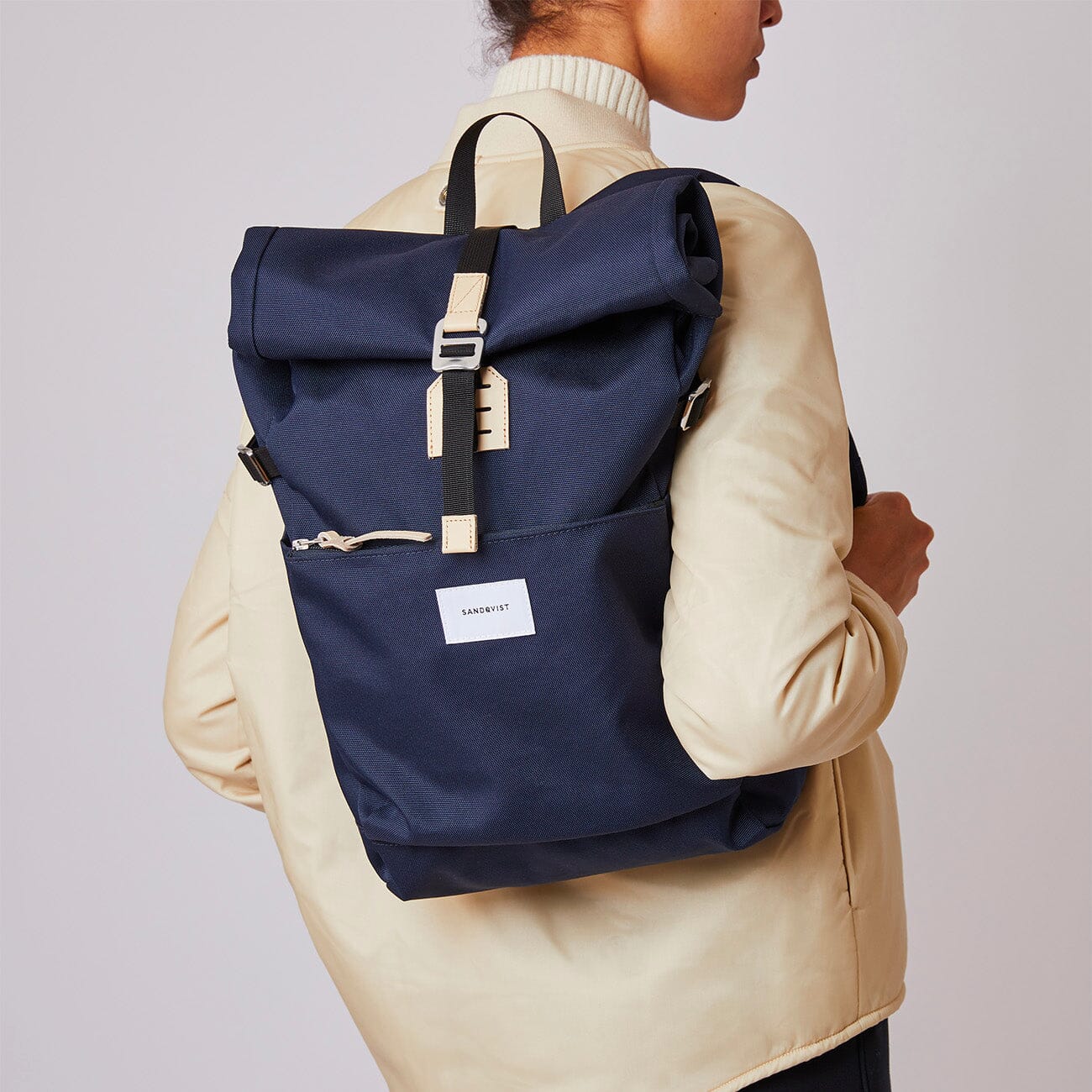 femme portant petit sac à dos roll top recyclé bleu