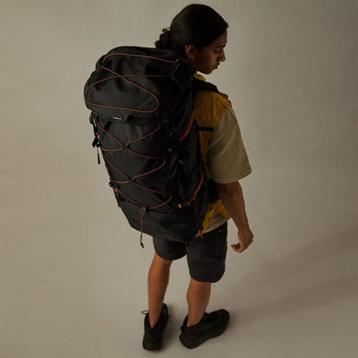 woman wearing the trail hike backpack in black in a studio setting