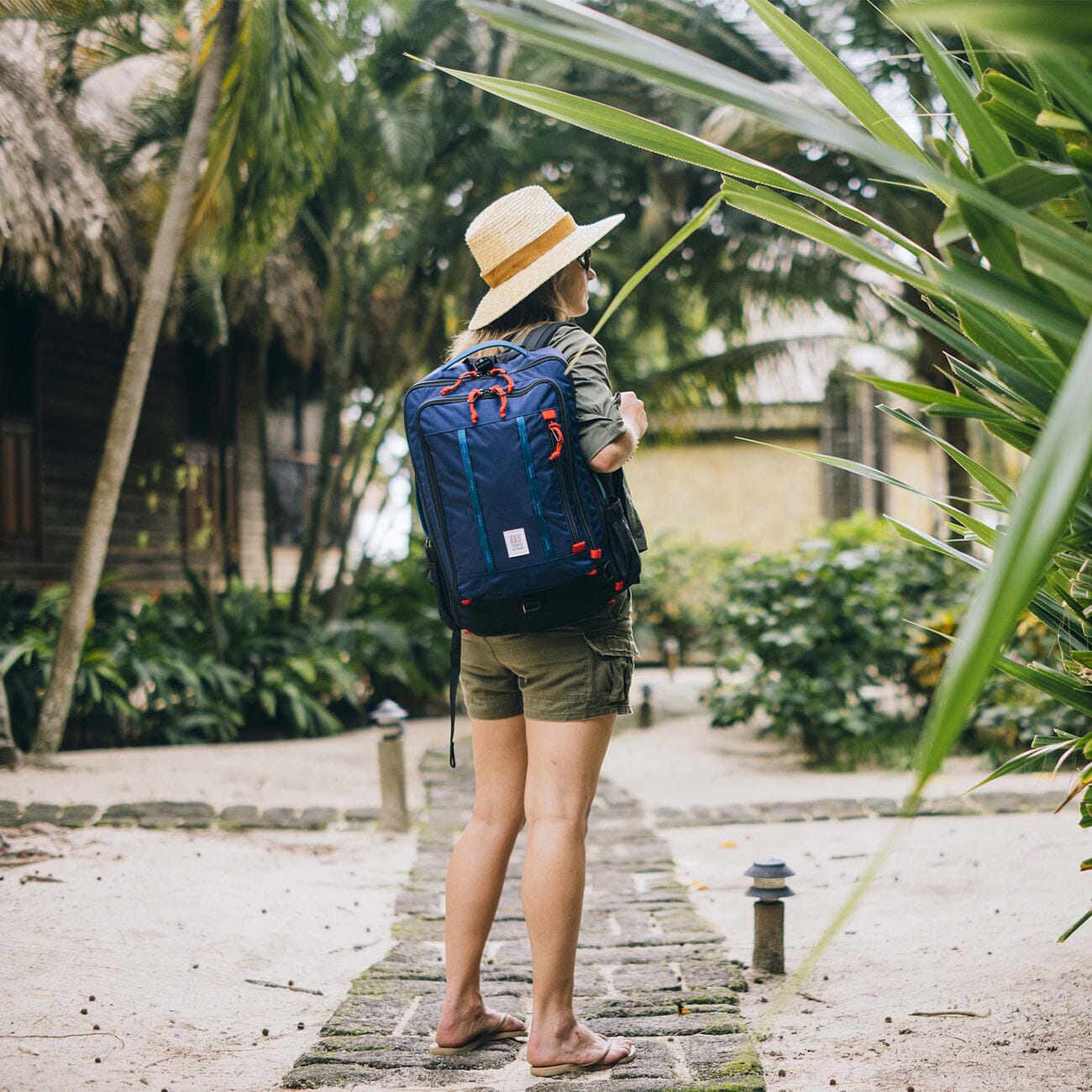 woman travel wearing navy blue topo design global travel pack