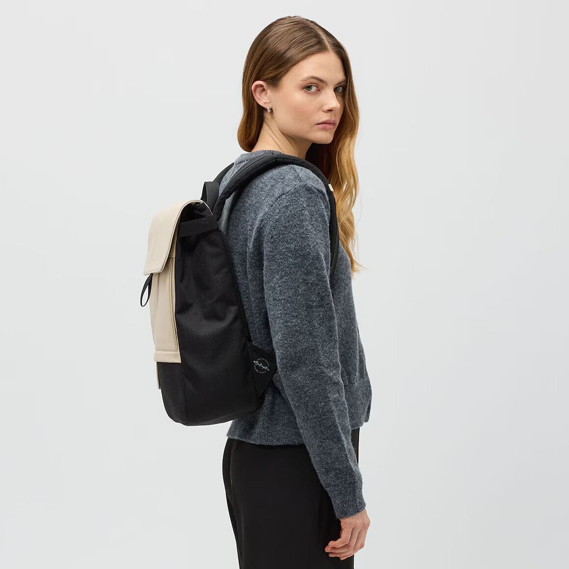 woman wearing cream black fyn backpack kapten son side