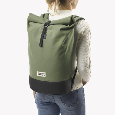 woman wearing cypress green roll top squamish backpack mero mero rolled lateral view