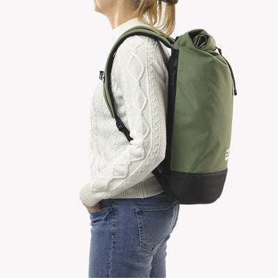 woman wearing cypress green roll top squamish backpack mero mero side view