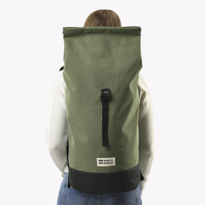 woman wearing cypress green roll top squamish backpack mero mero unrolled back view