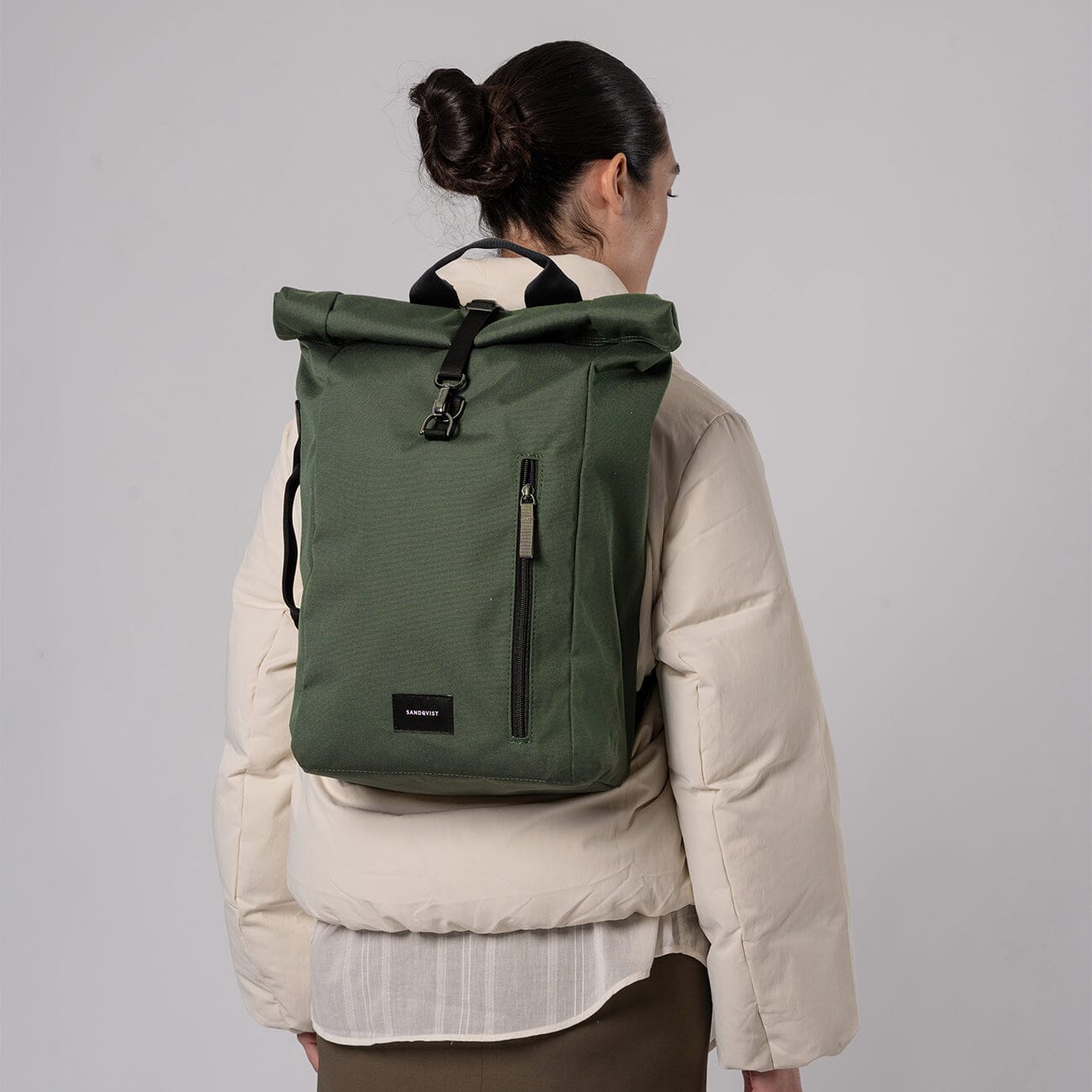 woman wearing dante vegan sandqvist backpack green