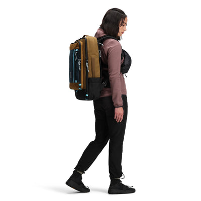 woman wearing global travel bag 40L side