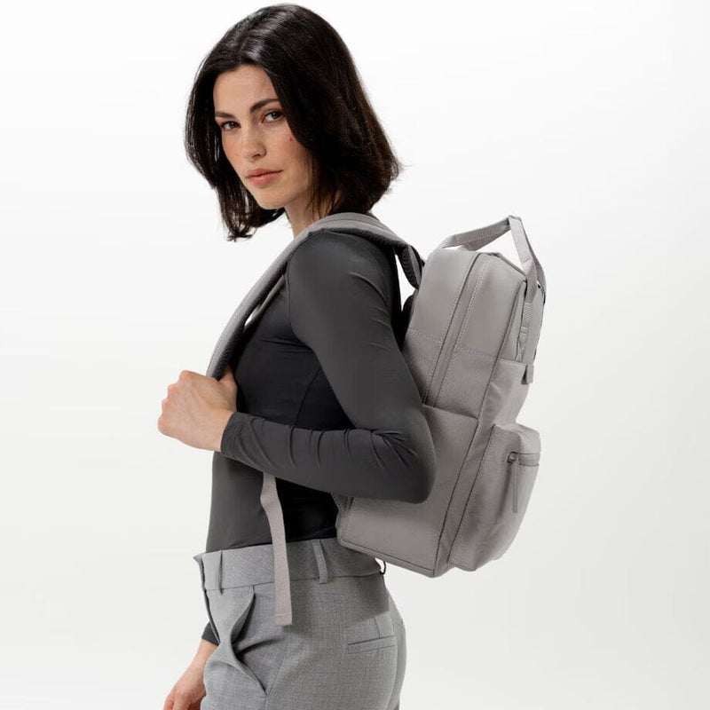 woman wearing greige bergen pro backpack kapten son