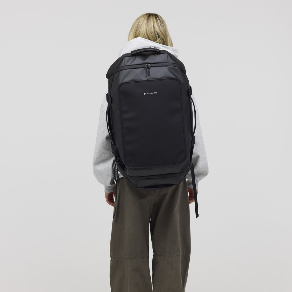 Woman wearing the black Lisbon Duffle Large, rear view