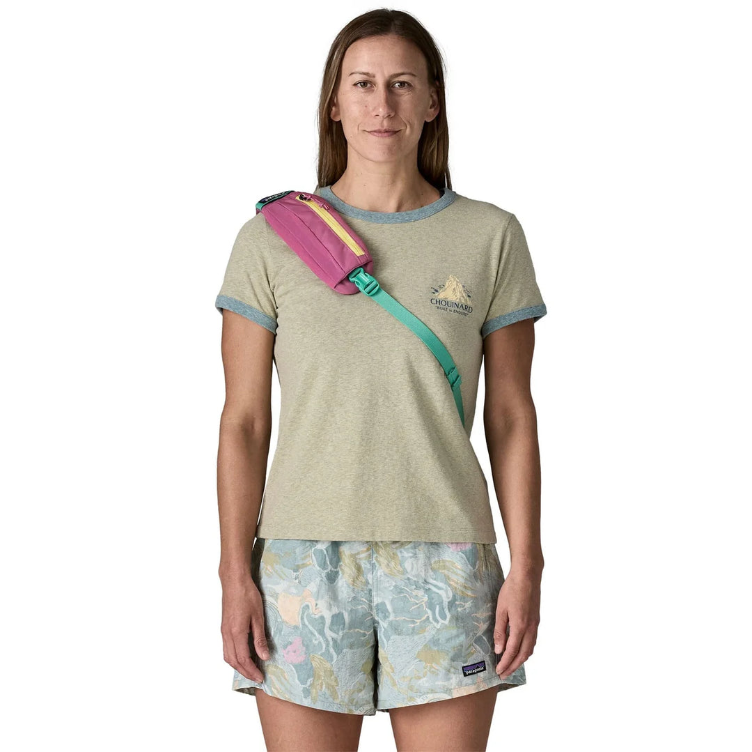 Woman wearing the Atom Sling 8L Faded Magenta crossbody seen from the front