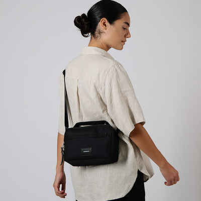 woman wearing sandqvist olof convertible cross body bag