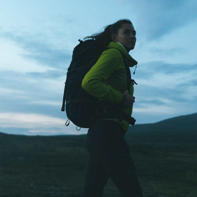 woman hiking wearing water resistant trek bag