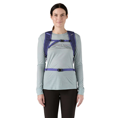 Woman facing forward with a Solstice Purple trail backpack featuring chest and hip belts