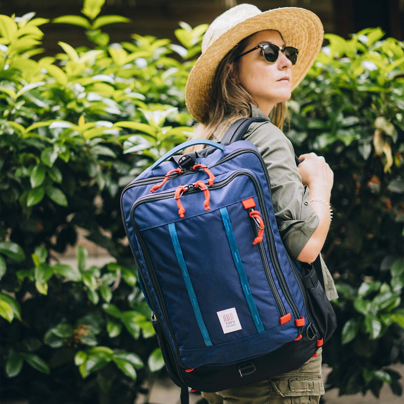 women traveling wearing navy blue topo design global travel pack