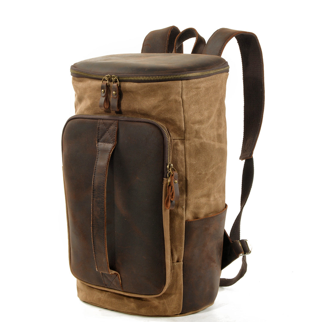 Three-quarter angle of the khaki Amsterdam vintage rucksack showing depth, side leather cargo pocket and twin shoulder straps