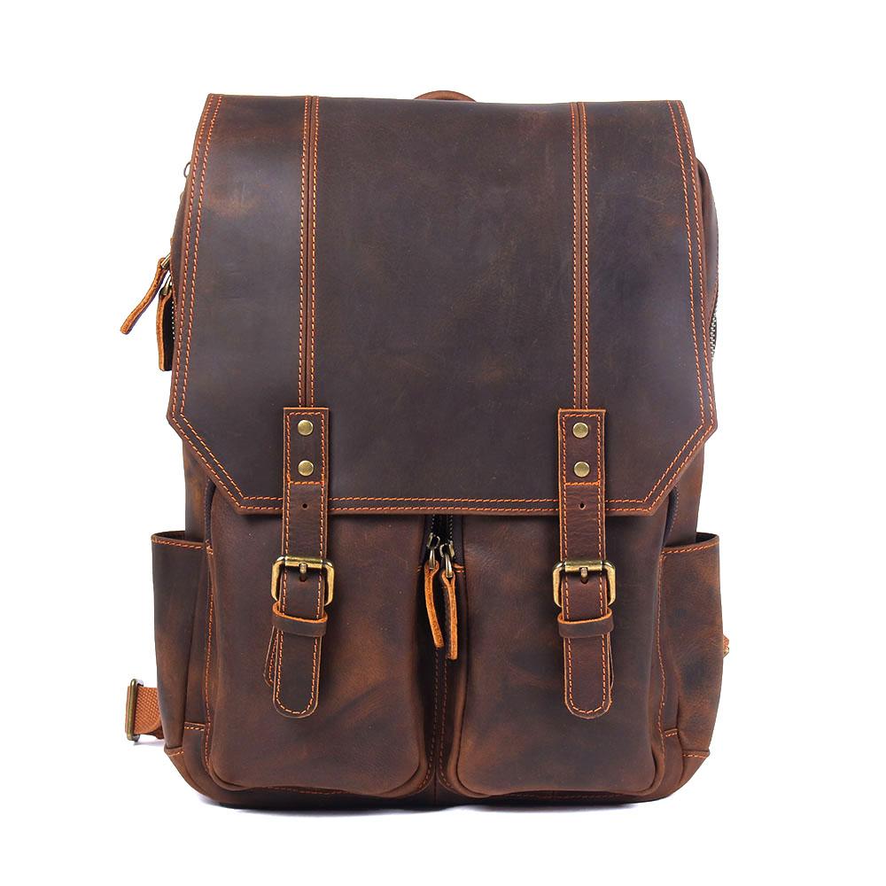brown leather rucksack with adjustable straps and laptop sleeve
