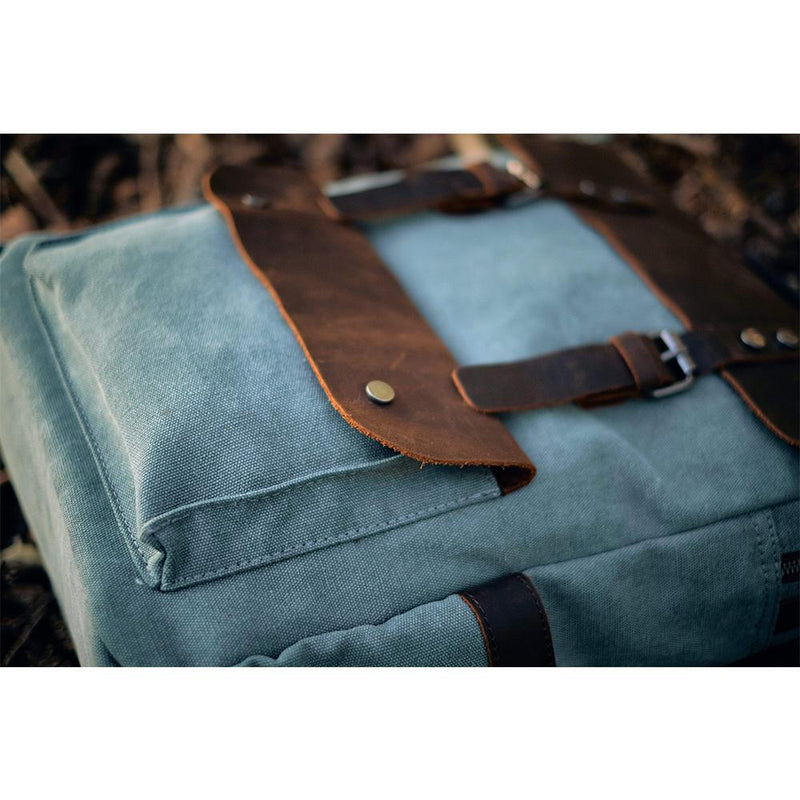 canvas and leather backpack helsinki close up, front clipped pocket with leather cap