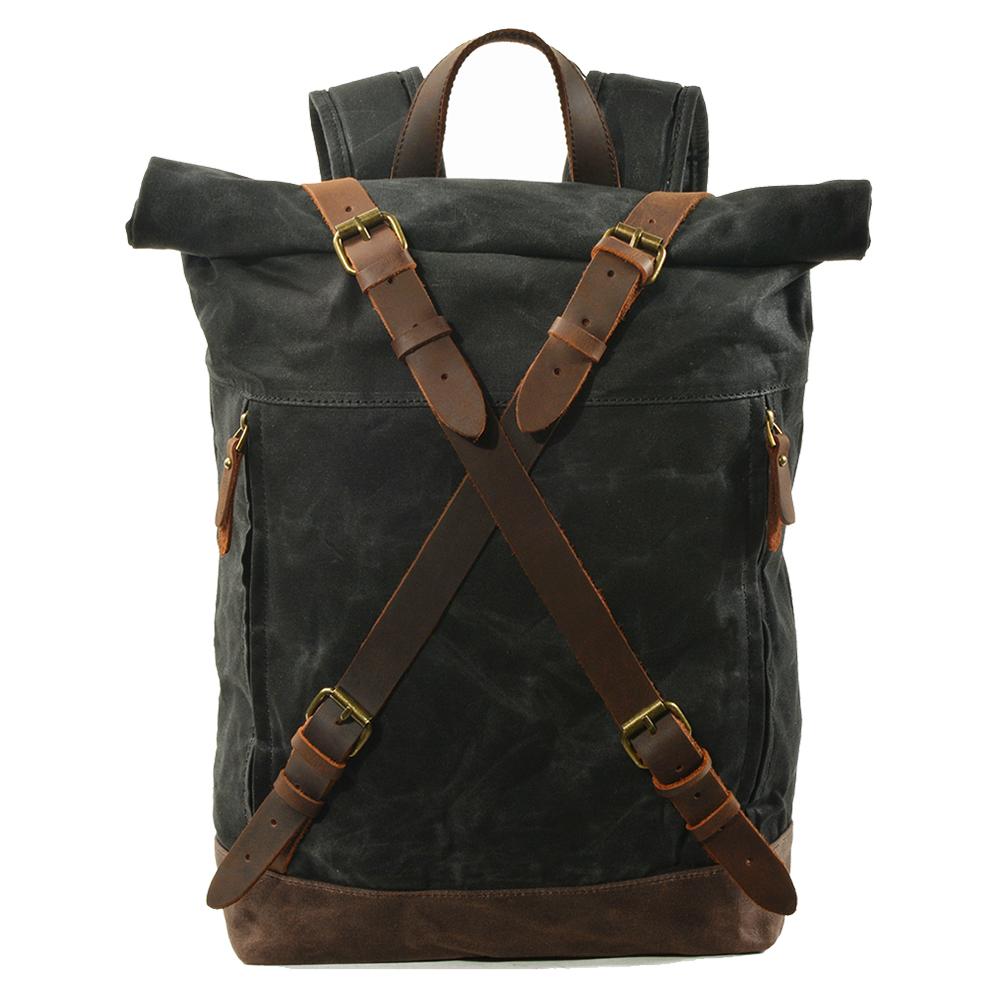 Canvas rucksack backpack in black with criss-cross full-grain leather strap closures, antiqued brass buckles and minimalist silhouette — Oslo