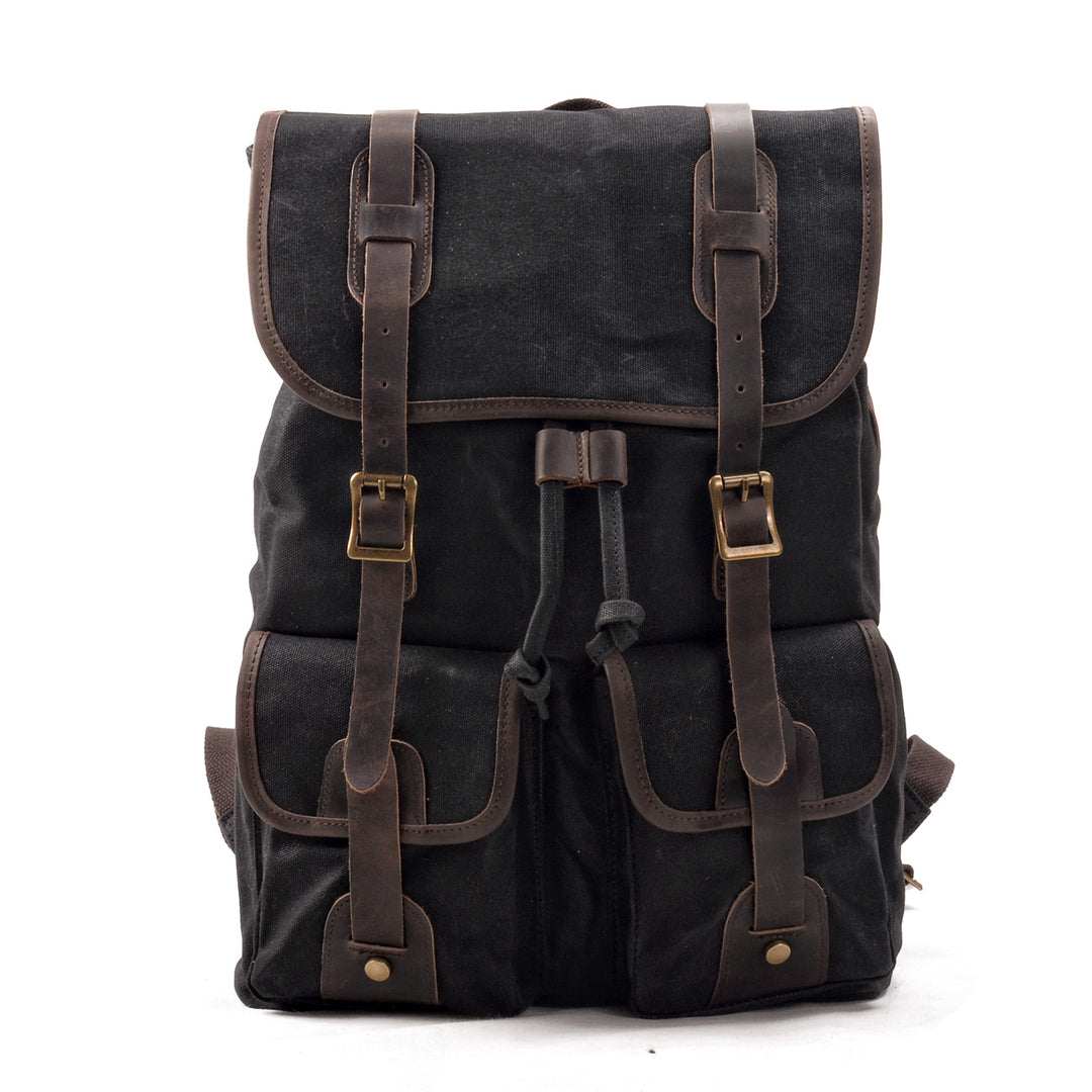 Canvas travel backpack in black with crazy horse leather straps, twin front cargo pockets and brass buckles, Eiken Calgary model