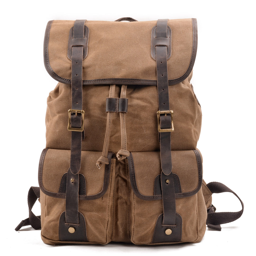 Vintage travel backpack in khaki tan waxed canvas with full-grain leather strap closures and twin front cargo pockets, Eiken Calgary model