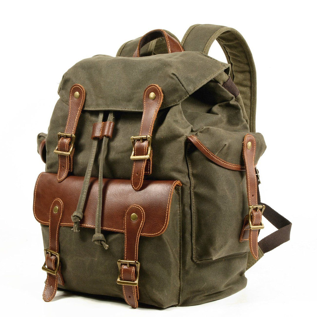 Three-quarter view of the army green Chamonix old school rucksack revealing depth, side cargo pocket and leather flap detail