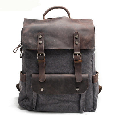 dark grey canvas and leather rucksack, front view