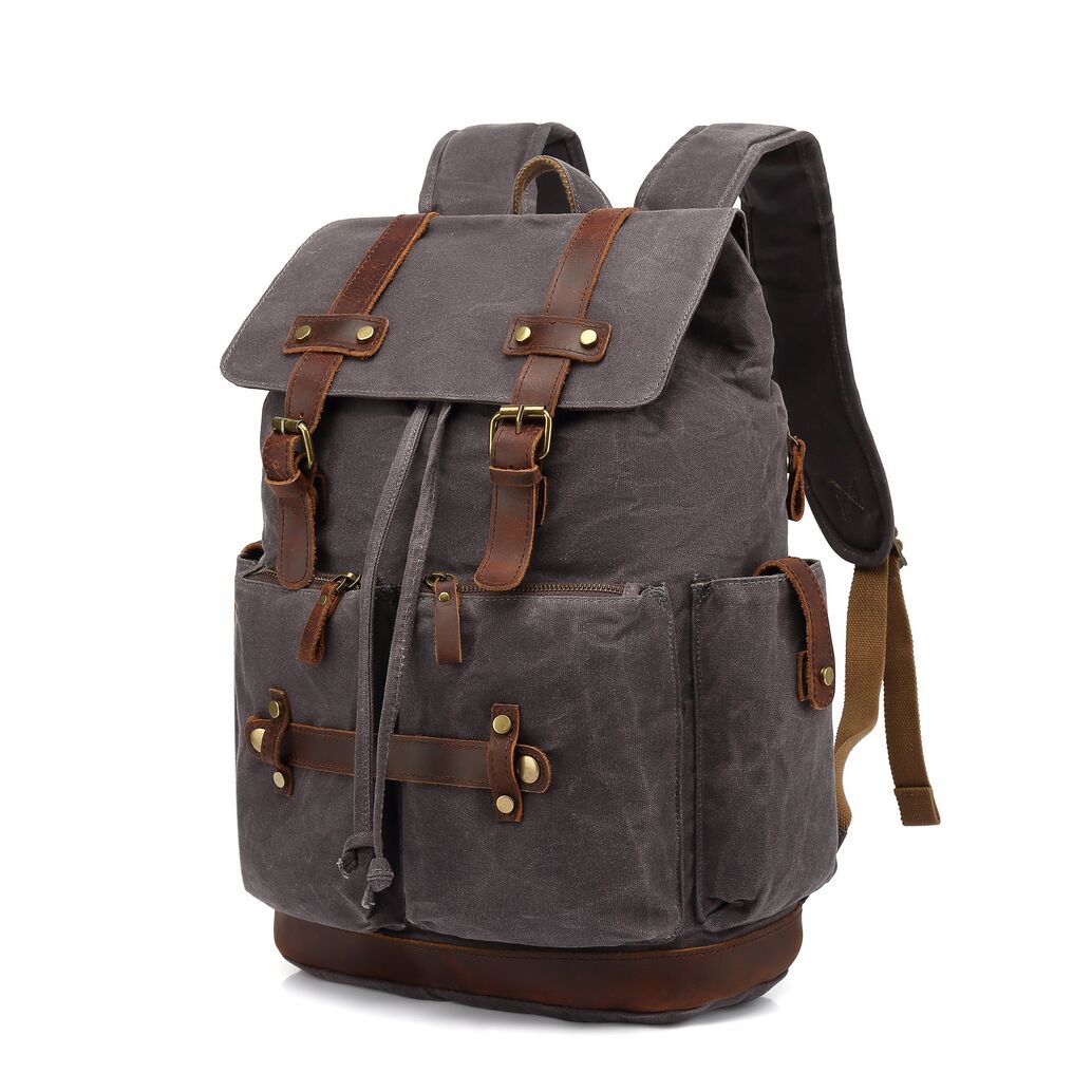 Three-quarter view of the army rucksack revealing depth, side panel detail and twin leather strap closures, Eiken Gotland model